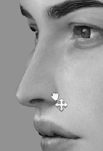 a woman with a nose piercing in the shape of a cross on her left side