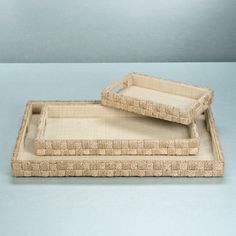 two woven trays sitting on top of each other