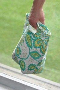 a person's foot sticking out of a window sill holding a bag in their hand