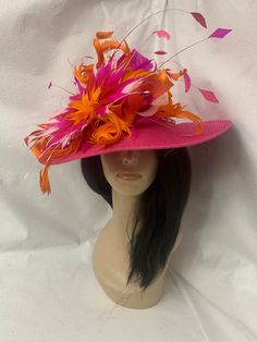 "This is a wide Brim Kentucky Derby style hat with an extra large blooming feather flower in variation of red, light pink and fuchsia hot pink and orange. Adorned with long floating Diamond shape feathers for a beautiful eye catching headpiece perfect to wear to Kentucky derby, oaks day, garden wedding, Tea Party hat, Mother's Day brunch hat, or Mother of the bride wedding hat. On a grand scale, this hat is a great for photos for birthday party Photoshoot. Design to wear on either side Wide Brim 23\" Ready to ship  Easy to wear Dramatic look when tilted" Fancy Tea Party, Kentucky Derby Style, Fancy Tea, Oaks Day, Classy Hats, Tee Party, Party Photoshoot, Tea Party Wedding, Wedding Tea