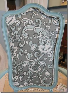 a blue and white chair sitting on top of a table