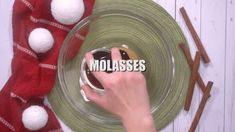 someone is holding the word molassses in front of a plate with red and white decorations