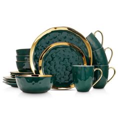 green and gold dinnerware set with matching cups, saucers, and plates on white background