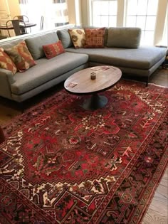 a living room filled with furniture and a large rug