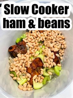 a bowl filled with beans and meat on top of a white table next to the words slow cooker ham and beans