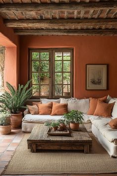 a living room filled with lots of furniture and plants on top of a coffee table