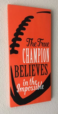 the true champion believes in the impossibleible book is displayed on a wall