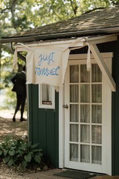 a small shed with a sign on the door