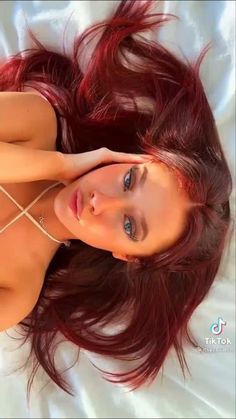 Celebs With Red Hair, Dark Red Eyebrows, Bright Red Hair On Brown Skin, Maroon Hair Aesthetic, Cherry Red Hair Blue Eyes, Burgundy Hair Blue Eyes, Cherry Hair Aesthetic, Wine Red Hair With Blonde Highlights, Kitten Hairstyle