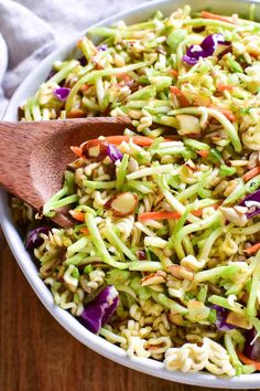 a salad with carrots, celery and sprouts in a bowl