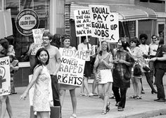 black and white photograph of people holding protest signs