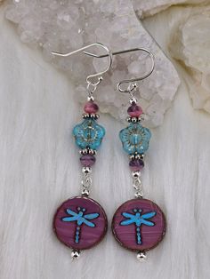 These beautiful Vintage style blue and Pink Dragonfly earrings are a wonderfully whimsical . Made with genuine Czech glass beads and Tibetan Silver components. Earrings measure 2 1/2 inches long and look stylish at every angle. Designed by BellaTreasuresByMT. A rare blue and pink mix of flowers, dragonflies, and rondelles. Also made with Sterling Silver French earrings wires that are hypoallergenic. Whimsical Blue Drop Earrings, Unique Blue Beaded Earrings Nickel-free, Unique Blue Beaded Nickel-free Earrings, Unique Blue Butterfly-shaped Jewelry, Unique Blue Butterfly Jewelry, Turquoise Czech Glass Earrings As Gift, Whimsical Blue Nickel-free Earrings, Whimsical Czech Glass Jewelry With Ear Wire, Nickel-free Blue Beaded Earrings As Gift