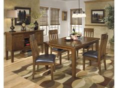 a dining room table and chairs in a room