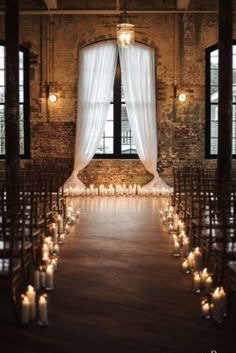 the aisle is lined with candles and drapes for an elegant wedding ceremony at anchor & veil