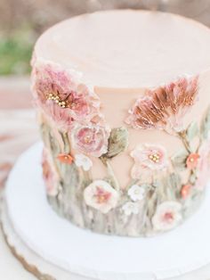 a close up of a cake with flowers on the frosting and icing decoration