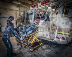 two women in front of an ambulance being loaded onto a stretcher