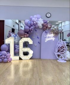 the number 16 is surrounded by balloons and flowers