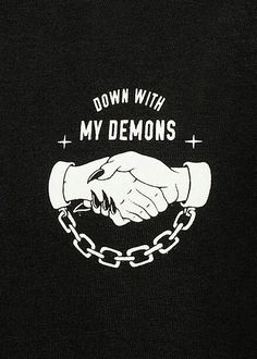 a black t - shirt with white lettering that says down with my demons on it