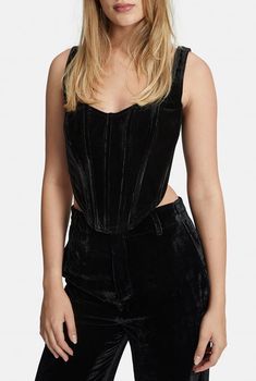 The flattering shape of the Fitted Velour Corset Bustier is dramatised by the soft sheen of the fabrication. Exposed binding and an asymmetrical hemline create dimension. The bold black hue is strong and powerful. Ideal for any event.Front curved hemline.Back straight hemline.Boning in casing at waist.Fitted.Main: 95% Polyester, 5% Elastane. Lining: 97% Polyester, 3% Elastane.Cold hand wash.Model is 5 ft, 7 in and wears a size 4. Stretch Velvet Top, Velvet Corset Top, Satin Corset Top, Velvet Corset, Corset Bustier, Strapless Corset, Velvet Top, Straight Line, Stretch Velvet