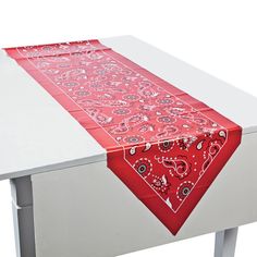 a red and white table runner with paisley designs