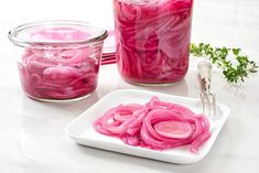 there is a bowl of pickled red onions on the table