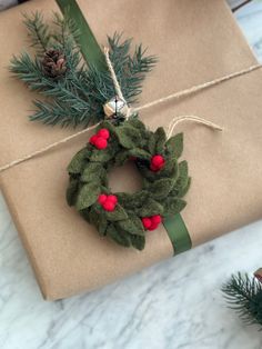 a present wrapped in brown paper with a wreath on it