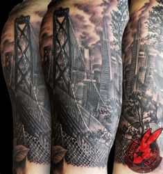 two men's legs with tattoos on them, one has a red bird and the other is a bridge