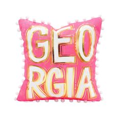 a pink and gold pillow with the word geo regia on it