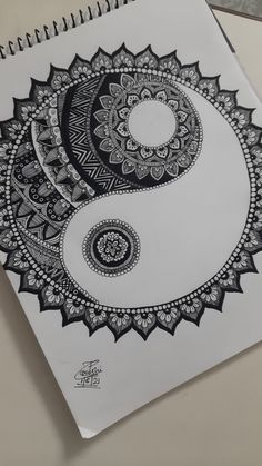 a spiral notebook with black and white designs on it