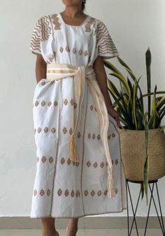 PRE ORDER!! This beatiful Mexican huipil (Mexican kaftan, or tunic) is made by Oaxaca artisan weaver in a very remote village in San Pedro de Amuzgos and pinacoteca (10 hours away from Oaxaca city). The huipil is made of organic cotton dyed with natural dyes all decorated by hand embroidered designs and  made in very ancient telar loom, hours and hours of work to have this beautiful piece of art! This unique huipil dress gives you an espectacular boho style cool and light to wear. Color: white Traditional White Thobe For Beach, Traditional White Thobe For Vacation, White Bohemian Kaftan For Spring, Bohemian White Summer Thobe, Bohemian White Thobe For Summer, Spring Bohemian Thobe, White Thobe For Beach In Spring, White Summer Thobe, White Long Thobe For Summer