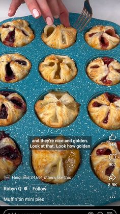 a blue tray filled with mini pies on top of a white countertop next to a person holding a fork