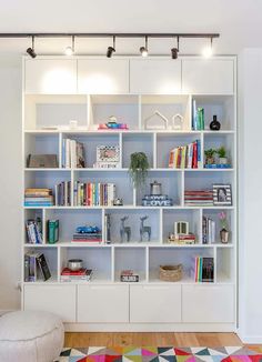 a white book shelf filled with lots of books