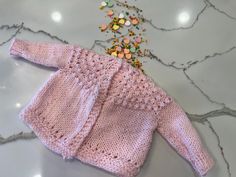 Bunny in a sweet baby pink, so soft and bright, this sweater wraps your little one in love's pure light. 100% hand-knit baby sweater. measurements chest circumference ≈ 24 inches length ≈ 11 inches sleeve length (underarm to cuff) ≈ 6.5 inches snuggles in every stitch: 100% hand-knit baby sweater wrap your little one in love with this 100% hand-knit baby sweater. every stitch is carefully crafted, creating a soft, cozy garment that is as warm as a hug. the sweater's delicate texture and timeless Pink Long Sleeve Knitting Pattern, Cozy Soft Knit Pink Cardigan, Cozy Pink Soft Knit Cardigan, Pink Hand Knitted Long Sleeve Sweater, Pink Long Sleeve Knitted Cardigan, Pink Knitted Cardigan For Spring, Cute Pink Soft Knit Cardigan, Spring Pink Knitted Cardigan, Handmade Pink Sweater For Winter