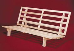 a wooden bench sitting on top of a red floor next to a white wall in front of a red background