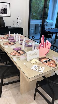 the table is set up for a party with decorations on it, including paper plates and candles