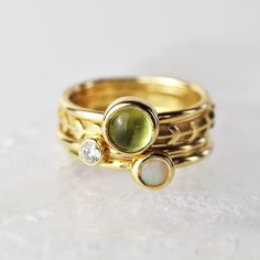 A stunning green peridot stacking ring made from solid 9ct yellow gold. Choose to wear the ring on its own, or mix and match it with other stacking rings from the Nebula collection, or why not add a sparkling Andromeda diamond ring? Peridot is a beautiful juicy green gemstone and the birthstone of August. It is one of only a few stones to come in only one colour, a lovely olive green and is said to bring a wonderful year to whoever wears it. It's warm glowing colour is a reminder of summer and o Stackable Green Diamond Ring In 14k Gold, Yellow Gold Peridot Stackable Rings For Wedding, Fine Jewelry Yellow Gold Stackable Rings For May Birthstone, Yellow Gold Peridot Stackable Rings For Anniversary, Green Gemstone Stackable Rings In 14k Gold, Stackable 14k Yellow Gold Moonstone Ring, Stackable Yellow Gold Rings For May Birthstone, Yellow Gold Stackable Rings For May Birthstone, May Birthstone Yellow Gold Stackable Rings