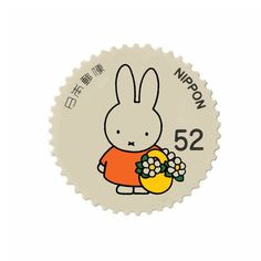 a white rabbit holding a bouquet of flowers in it's hand with the words nippon 52