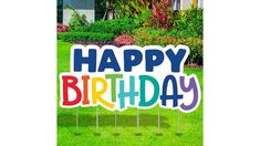 a happy birthday yard sign in the grass