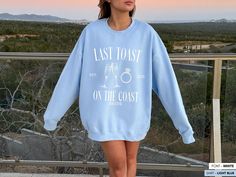 Elevate the bachelorette party experience with this exclusive and carefully crafted Last Toast sweatshirt. Made from premium cotton, this sweater guarantees not only exceptional style but also genuine comfort for the celebration, making it the perfect gift for bridesmaids and the bride-to-be at any bachelorette weekend. Note 👉🏼 You can expect a draft of your custom print within 24 hours for your review and approval. Please keep an eye out for a message! ITEM DETAILS * * Crewneck Sweatshirt, 50 Relaxed Fit Crew Neck Top For Bachelorette Party, Casual Cotton Tops For Bachelorette Party, Casual Crew Neck Top For Bachelorette Party, Casual Crew Neck Top For Honeymoon, Last Toast On The Coast Decor, Last Coast On The Toast, Summer Crew Neck T-shirt For Bachelorette Party, Bachelorette Party Graphic Print Crew Neck Top, Bach Shirts