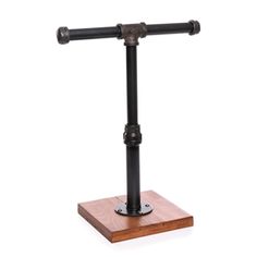 a wooden stand with two black metal pipes on it's sides and a white background