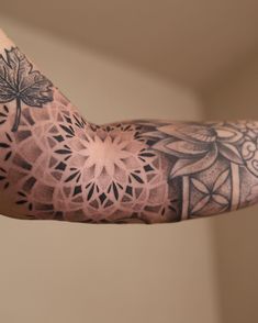 a man's arm with an intricate tattoo design on the left side of his arm