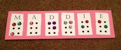 a pink board with different colored stones and words that spell out the word maddie