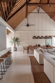 a living room filled with furniture next to a kitchen