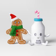 two gingerbreads and a milk bottle with a candy cane