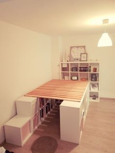 a room with a bed, bookshelf and shelves