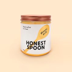 a jar of honey with a spoon on it's lid that says, honest spoon