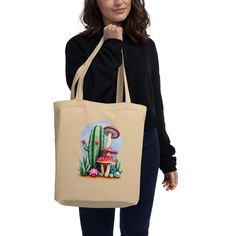 Say goodbye to plastic, and bag your goodies in this organic cotton tote bag. There's more than enough room for groceries, books, and anything in between. * 100% certified organic cotton 3/1 twill * Fabric weight: 8 oz/yd² (272 g/m²) * Dimensions: 16″ × 14 ½″ × 5″ (40.6 cm × 35.6 cm × 12.7 cm) * Weight limit: 30 lbs (13.6 kg) * 1″ (2.5 cm) wide dual straps, 24.5″ (62.2 cm) length * Open main compartment This product is made especially for you as soon as you place an order, which is why it takes Eco-friendly Organic Cotton Canvas Tote Bag, Organic Cotton Canvas Bag For Gift, Eco Tote Bag, A Plus, Cotton Tote Bags, Fabric Weights, Organic Cotton, Bathing Beauties, Accessory Gift