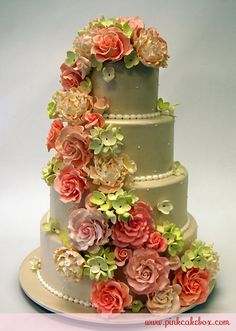 a three tiered wedding cake decorated with flowers