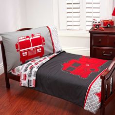 a bed room with a neatly made bed and a dresser next to the bed covered in a blanket