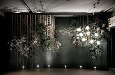 a room with flowers and candles hanging from the ceiling